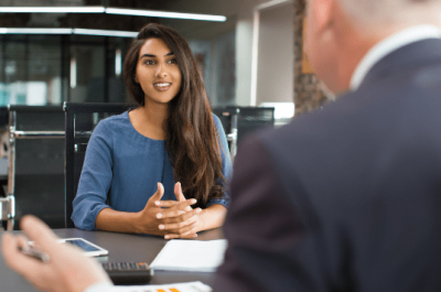 smiling-female-client-talking-male-manager